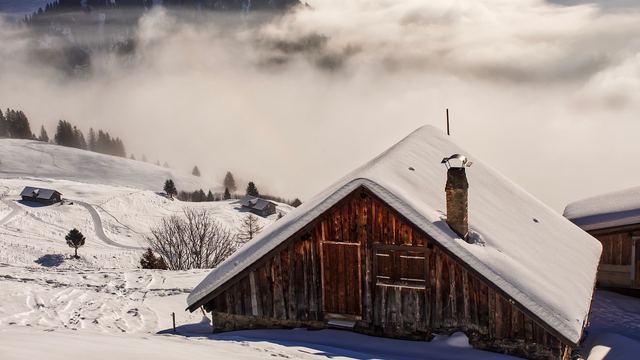 Holzhütte mit Schnee auf dem Dach